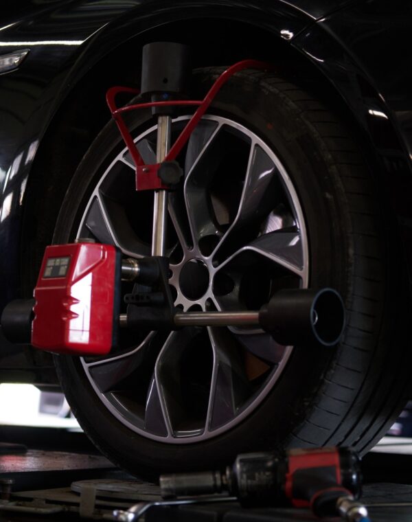 Closeup photoshoot of process or tyre balancing at dark auto service.